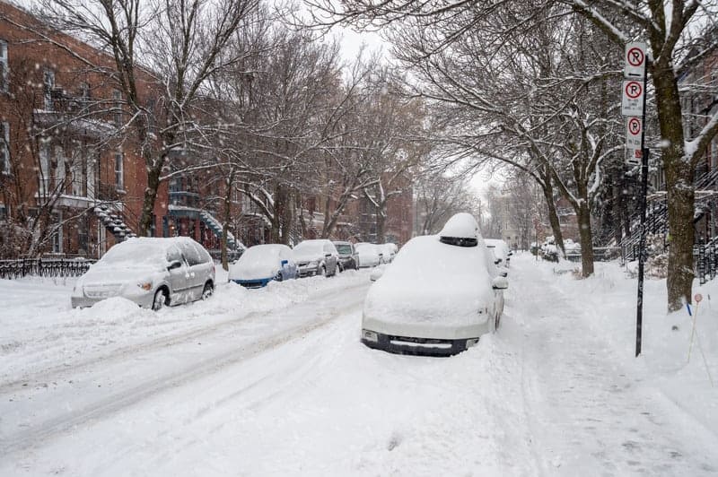 Cars covered in snow during snowstorm in Montreal