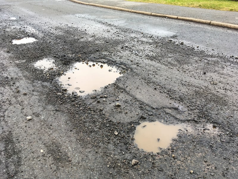 Pot holes in tarmac road surface