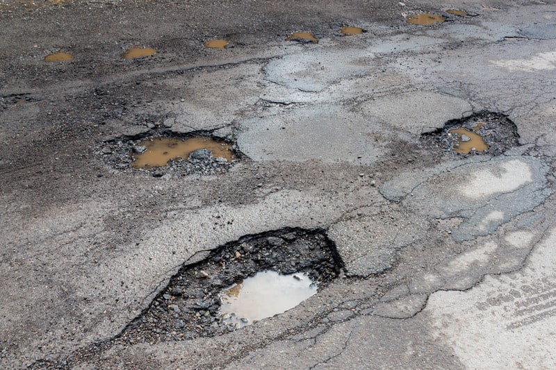Potholes On A Paved Road